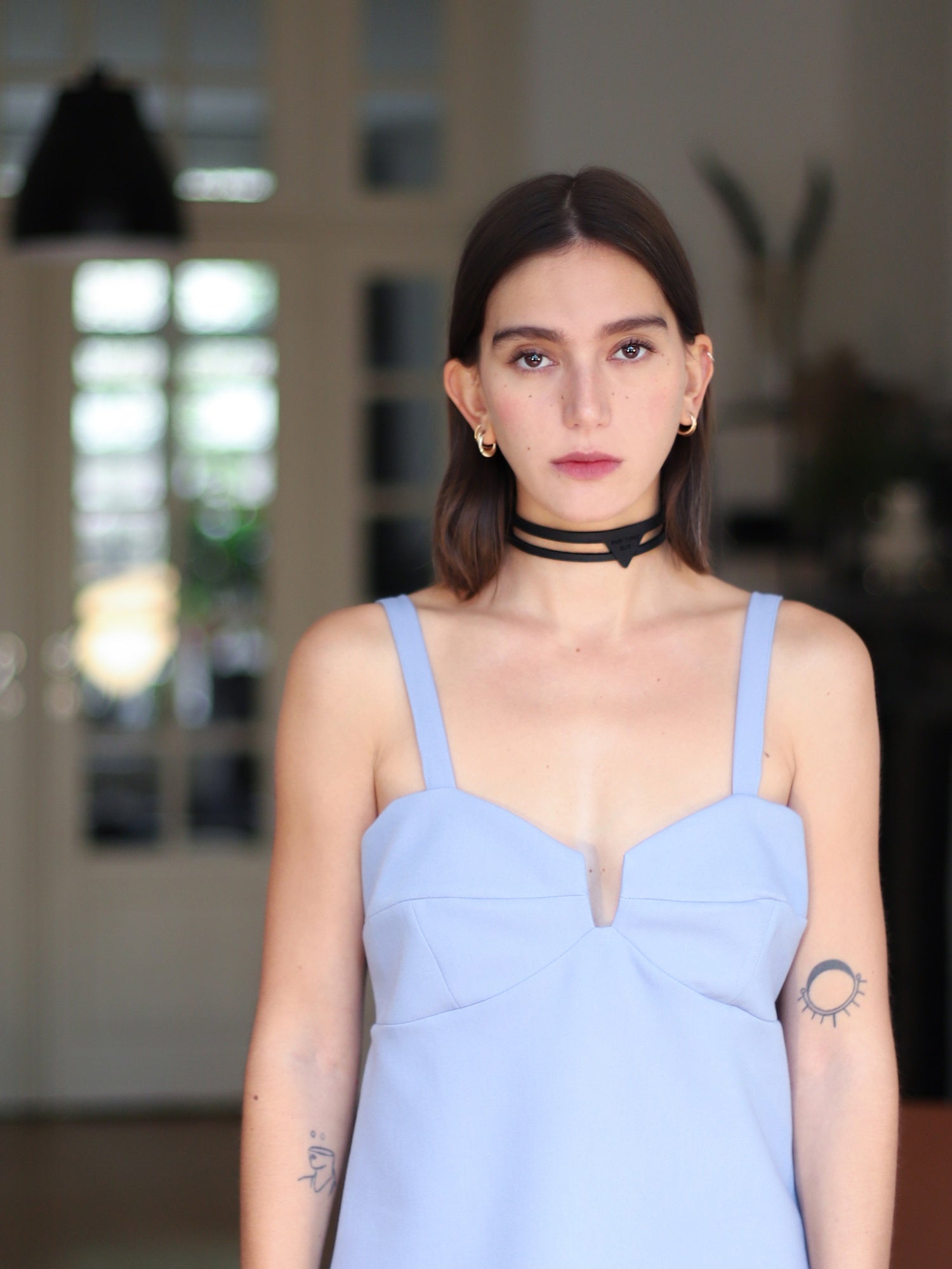 Manon indoors wearing the handmade Foulard chokerby Baby turns Blue Paris