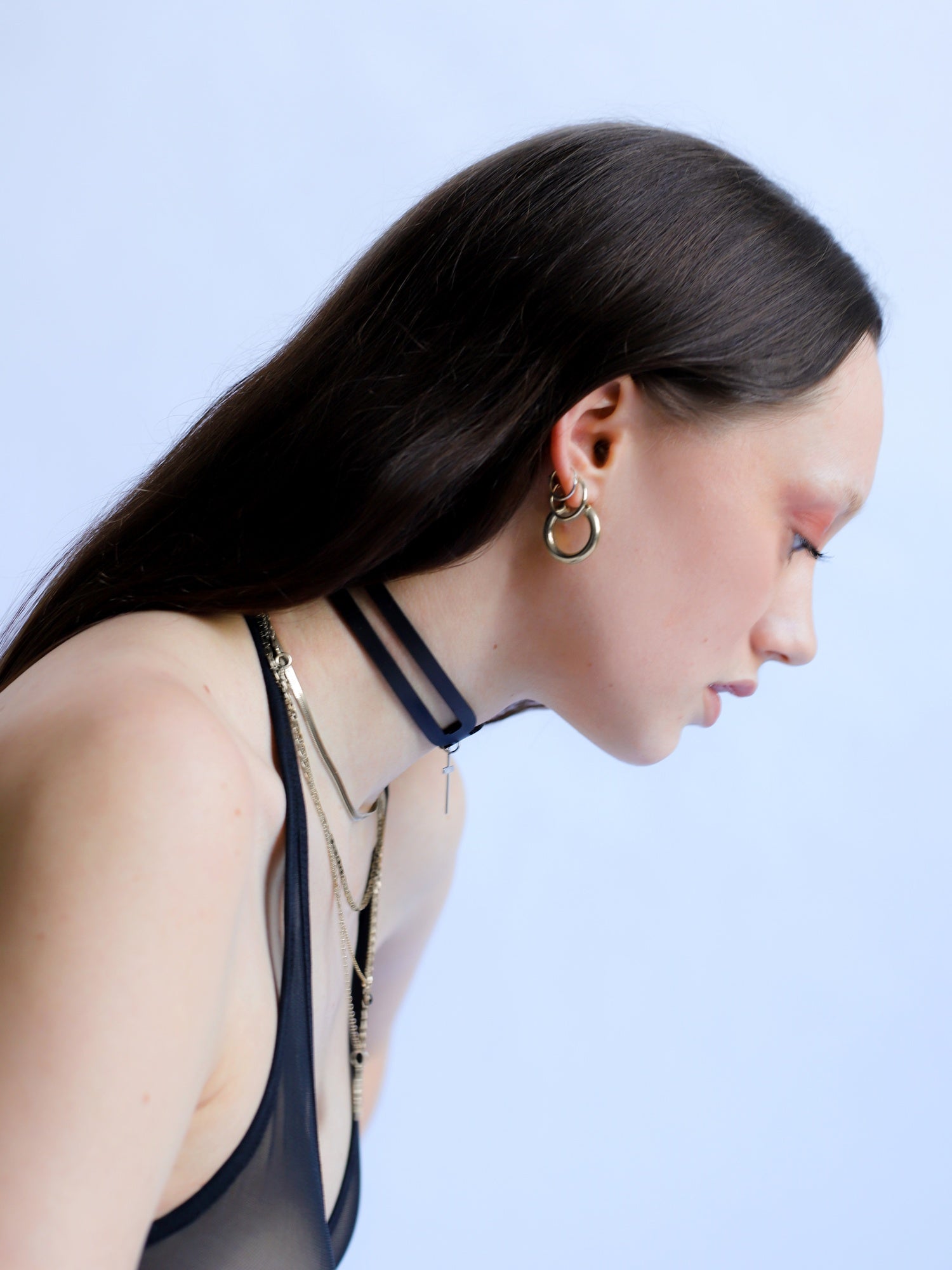 Side view of Tessa wearing the Hope Cross choker with cross pending by Baby turns Blue Paris