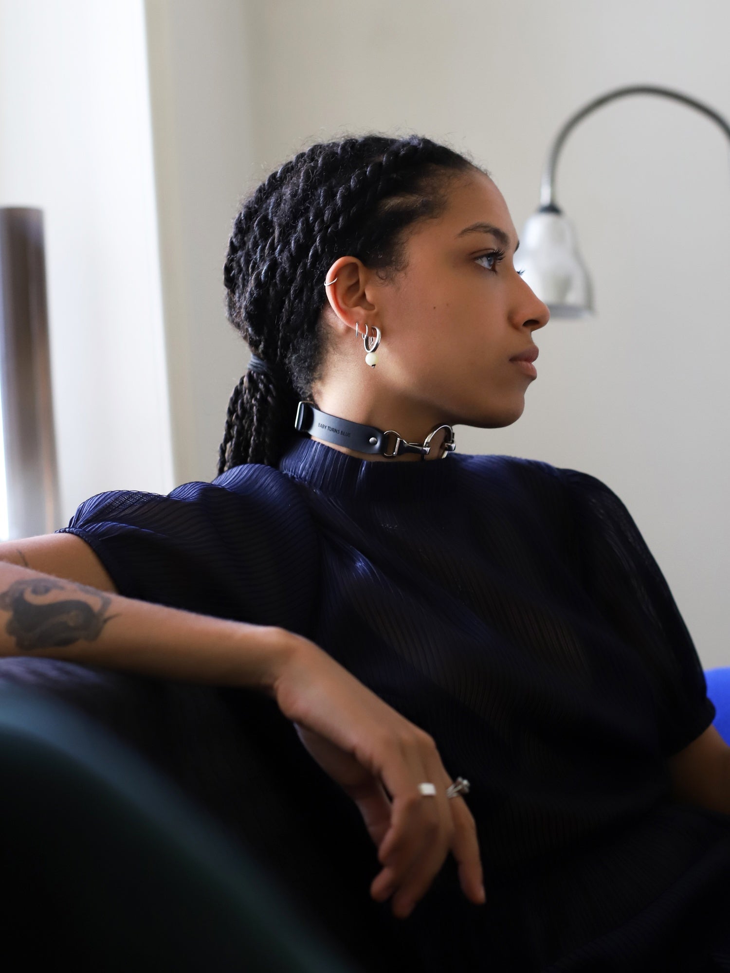 Lisa sitting at home with the Lula choker around the neck by Baby turns Blue Paris