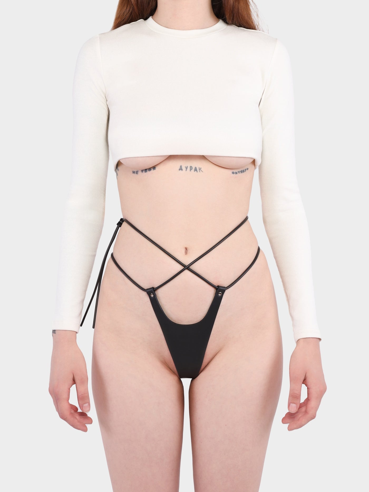 Front view of a model wearing the vegan Pulse thong by Baby turns Blue Paris