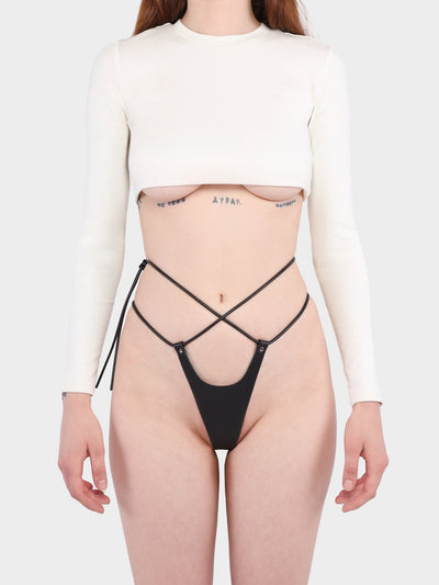 Front view of a model wearing the vegan Pulse thong by Baby turns Blue Paris