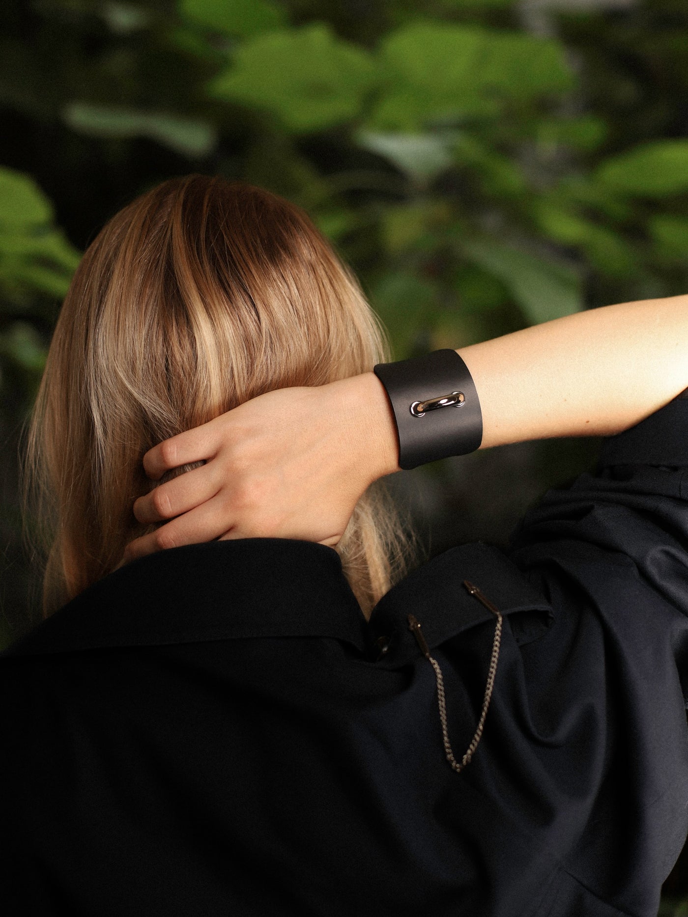 Back view of model holding her head with the Dee cuff at the wrist by Baby turns Blue Paris