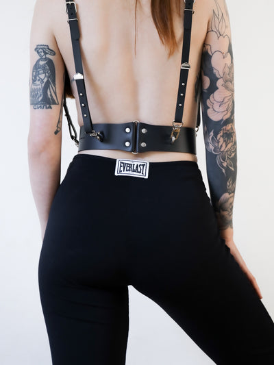Close-up of Marija featuring the back of the Baby turns Blue Paris Jean vegan leather harness